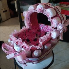 a pink and white heart shaped basket on top of a table