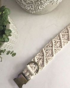 a white lace belt next to a potted plant