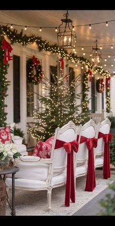 white chairs with red bows on them are lined up outside the house for christmas time