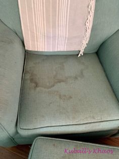 a dirty chair and ottoman in a room