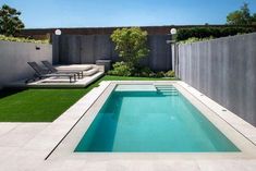 an empty swimming pool in the middle of a backyard