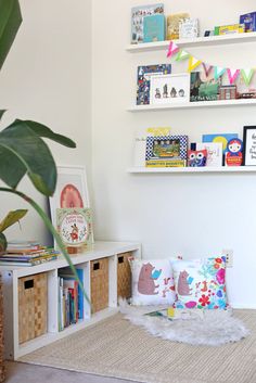 a living room with bookshelves filled with children's books