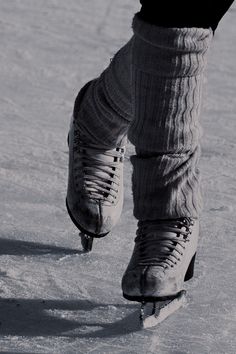 the legs and feet of a person wearing ice skates