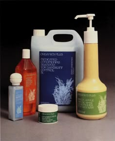 an assortment of hand soaps and lotion bottles on a gray surface with black background