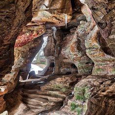 the inside of a cave with water coming out of it