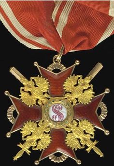 an award medal is displayed on a black background with red and gold ribbons around it