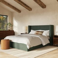 a bedroom with a bed, nightstands and windows