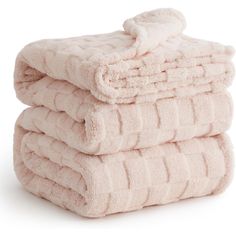 three pink towels stacked on top of each other