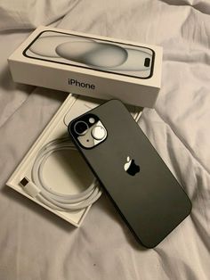 an iphone in its box on top of a bed