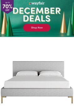 a bed with white sheets and pillows in front of a green banner that says wayfair