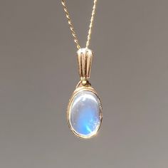 9k yellow gold rainbow moonstone pendant. New production. Each moonstone is natural and one-of-kind and may have natural inclusions. Moonstone: 8 x 6 mm oval cut cabochon Pendant: 18.5 x 7.5 mm Weight: 1.5 grams Pendant only, chain not included. Handmade 14k Gold Oval Cabochon Jewelry, Oval Cabochon Moonstone Jewelry, Elegant Untreated Moonstone Jewelry, Moonstone Gemstone Jewelry In Oval Cabochon, Dainty Moonstone Jewelry With Cabochon, Oval Moonstone Gemstone Jewelry, Handmade 14k Gold Oval Moonstone Ring, Oval Moonstone Yellow Gold Jewelry, Yellow Gold Moonstone Jewelry With Oval Shape