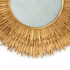 a mirror that is on top of a wooden frame with spikes in the shape of a sunburst