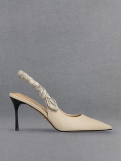 In a soft shade of chalk white, these slingback pumps exude understated elegance. They feature ruched slingback straps adorned with a monogram print, adding an interesting detail to the otherwise minimalist design. Set on 8cm stiletto heels, they promise an extravagant style and height boost for all kinds of occasions, from work meetings to dinner dates. Embrace effortless elegance with this pair as they are versatile enough to complement any ensemble. Elegant Cream Slingback Pumps For Spring, Classic Cream Slingback Pumps For Spring, Spring Beige Slingback Pumps With Padded Heel, Chic Beige Slingback Pumps For Formal Occasions, Cream High Heel Slingback Pumps For Spring, Luxury Padded Heel Slingback Pumps For Spring, Chic Beige Slingback Pumps With Ankle Strap, Beige Slingback Pumps With Wrapped Heel For Evening, Chic Cream Slingback Pumps For Party