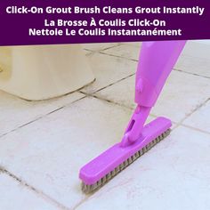 a purple brush is on the floor in front of a white toilet and pink tile