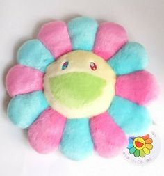 a colorful flower shaped plush toy on a white surface