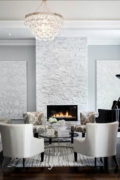 a living room filled with furniture and a piano in front of a fire place on the wall