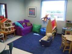 a child's playroom with toys and stuffed animals on the walls, blue carpet