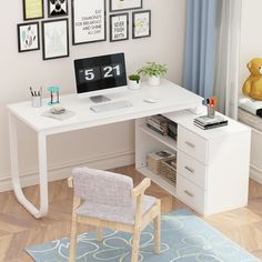 a white desk with a computer on it in front of pictures and a teddy bear