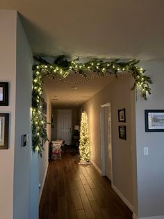 the hallway is decorated for christmas with garland and lights