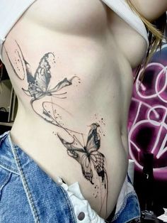 a woman with a butterfly tattoo on her stomach