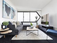 a living room filled with furniture and a large window