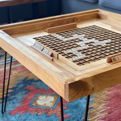 a coffee table that has some sort of board game on it with hairpin legs