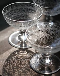 three glass goblets sitting on top of a table