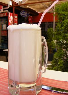 a large glass mug filled with liquid on top of a table