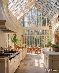 a kitchen with a large glass ceiling and lots of counter space