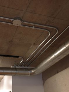 the pipes are attached to the ceiling in this room