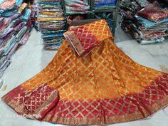 "Thank you very much for visiting my shop. Material-Art Silk Lehenga with Heavy Banarsi Bandhej Lengha Dupatta - Ghat chola Banarsi Bandhej Dupatta. Accompanied with unstitched blouse piece Blouse - Running Blouse Blouse length: 0.80 mtrs Easy to wear and very comfortable  It Gracefully Add Style To Your Attire & Match With Your Confidence Disclaimer: Colors may slightly vary due to Photographic effects IMPORTANT NOTE : Please Be aware that Similar Looking Products of LOW QUALITY are Being Sold Multicolor Anarkali Banarasi Silk Lehenga, Anarkali Multicolor Banarasi Silk Lehenga, Semi-stitched Banarasi Silk Lehenga For Festivals, Orange Anarkali With Bandhani Print, Art Silk Choli With Dupatta For Festival, Festival Banarasi Silk Sharara With Bandhani Print, Orange Banarasi Silk Lehenga For Eid, Bollywood Chanderi Choli With Bandhani Print, Fitted Bandhani Print Sets For Festival