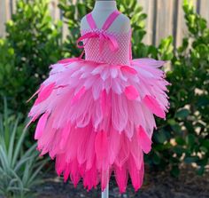 a pink and white tutule dress on a mannequin headdress