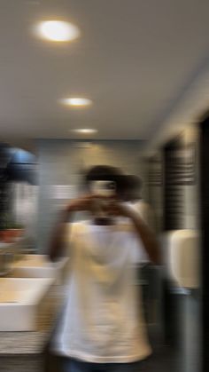 a blurry photo of a woman taking a selfie