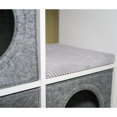 there are two speakers on top of each other in the same room, one is grey and the other is white