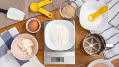 the kitchen scale is full of ingredients for making cake batter and other things to make it