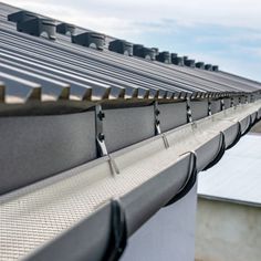 the roof of a building with metal gutter