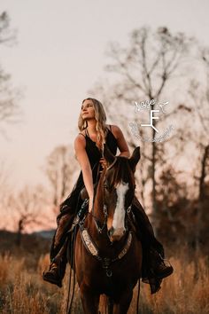 a woman riding on the back of a brown horse