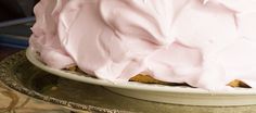 a close up of a cake on a plate with frosting and icing over it