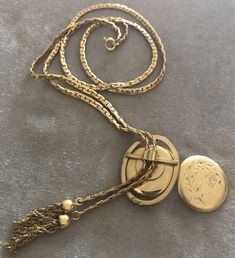 "Vintage A-C 12K Gold-filled Locket Tassel Lariat Pendant Necklace. Size: Necklace- 29\"x 3/16\"(3mm). Locket: 1\"x1 1/4\" round. Markings: A-C 1/20 12KT GF. Beautiful. Sold as is. Pre-Owned." Bohemian Lariat Jewelry For Formal Occasions, Elegant Necklaces With Latkans, Elegant Round Necklaces With Latkans, Elegant Latkans Necklace As A Gift, Formal Long Locket Necklace, Antique Lariat Jewelry Gift, Antique Lariat Necklace As Gift, Elegant Locket Necklace With Adjustable Chain For Formal Occasions, Elegant Formal Locket Necklace With Adjustable Chain