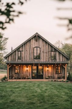 a large wooden house sitting on top of a lush green field