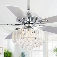 a chrome ceiling fan with crystal chandelier hanging from it's center blade