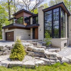 a modern house with large windows and stone steps