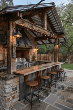 an outdoor bar with stools and lights