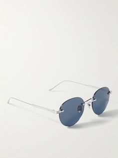 Cartier Eyewear's frameless sunglasses are both sleek and lightweight. They have a slim, silver-tone nose bar and arms, plus cool blue lenses. Frameless Sunglasses, Cartier Sunglasses, Silver Sunglasses, Aviator Style, Optical Glasses, Blue Lenses, Sunglasses For Men, Oval Frame, Gold Sunglasses