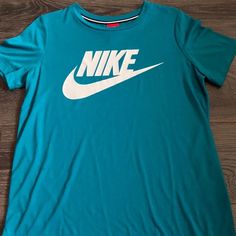 Teal Nike Tshirt Never Worn Unisex Nike Blue Short Sleeve T-shirt, Nike Blue Crew Neck T-shirt, Nike Green Graphic Tee, Blue Nike T-shirt With Logo Print, Nike Green Short Sleeve T-shirt, Green Nike Crew Neck T-shirt, Nike Blue T-shirt With Logo Print, Blue Crew Neck Top With Logo Print, Basic Blue Tops With Graphic Print