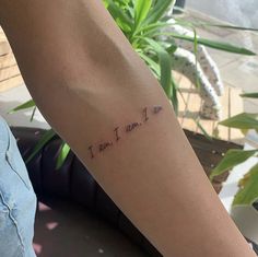 a woman's arm with the words i am, i am, i am written on it