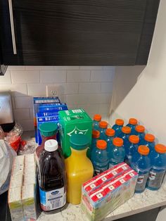 bottles of water and juice on a counter in a kitchen