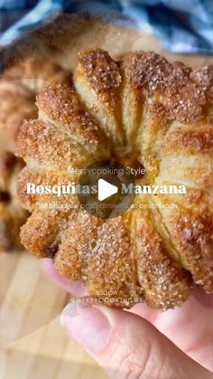 a person holding a pastry in their hand with the words roslutas manazzana on it