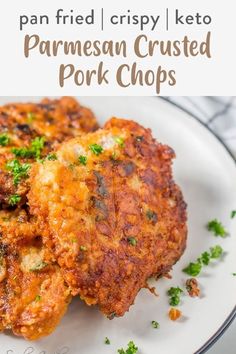 two pieces of parmesan crusted pork chops on a white plate