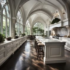 a large kitchen with lots of counter space and white cabinetry, along with an arched ceiling